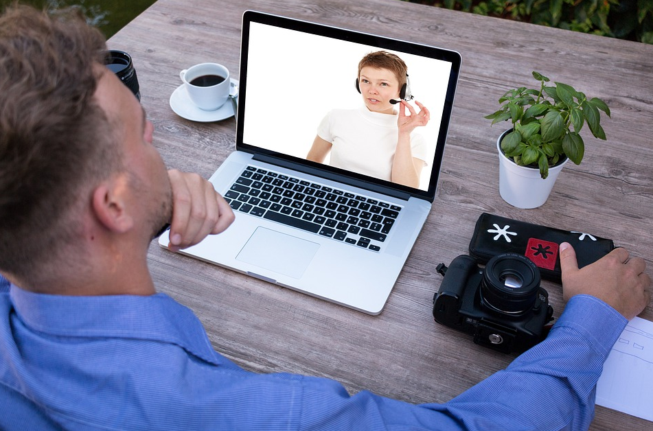 man looking at a laptop infront of him